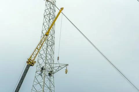 Electrical engineer or electrician use the crane to lift to repair the high v Stock Photos