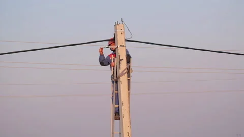 Electrical engineer performs installation work on a concrete pillar Stock Footage 151464691