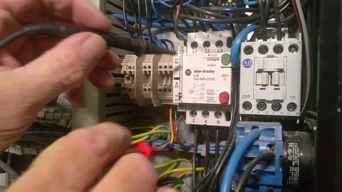 Electrical engineer testing switches in a control panel Stock Footage 117004671