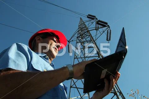 Electrical Engineer Under High Voltage Tower Stock Photos