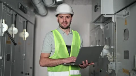 Electrical Engineer Using Laptop in Control Room, Inspecting Switchboard Stock-Footage 297167655