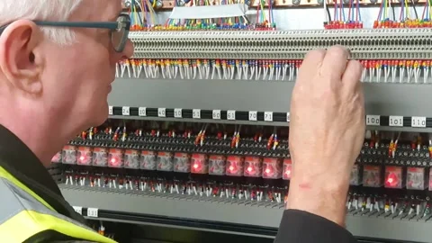 Electrical engineer using a screwdriver to check connections Stock Footage 336221364