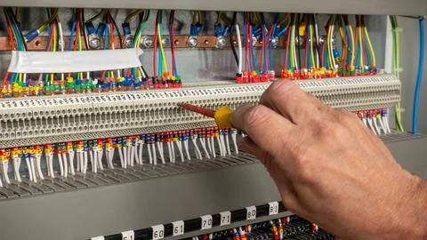 Electrical engineer using a screwdriver to check connections Stock Photos