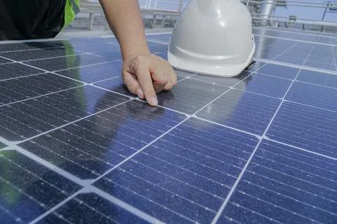An electrical engineer wearing a white hat is checking. Solar panel cleanline Stock Photos