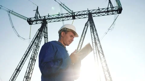 Electrical engineer worker in helmet a working with digital tablet, near tower Stock-Footage 149586307