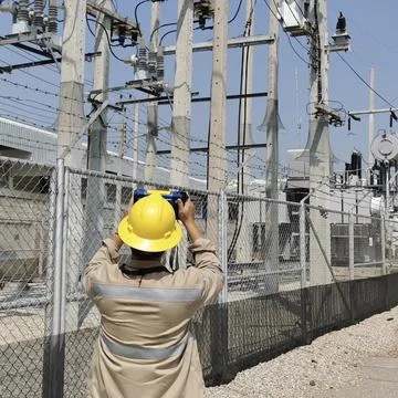 Electrical engineer worker using thermal imaging camera detector inspecting. Stock Photos