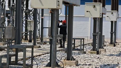 Electrical engineer worker wearing red safety helmet using thermal imaging. Stock Photos