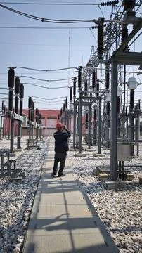 Electrical engineer worker wearing red safety helmet using thermal imaging .. Stock Photos