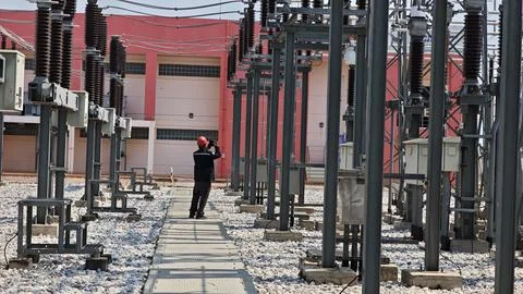 Electrical engineer worker wearing red safety helmet using thermal imaging .. Stock Photos