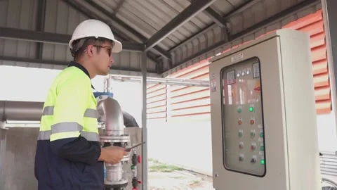 A Electrical Engineer working front HVAC control panels. Video stock 238432881