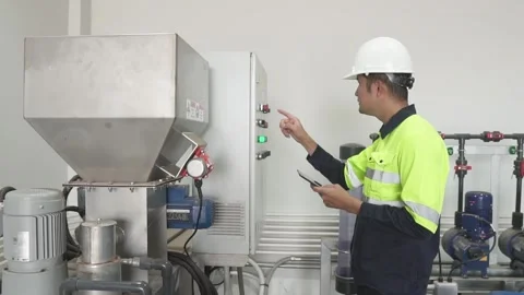 A Electrical Engineer working front HVAC control panels. Stock Footage 238432897