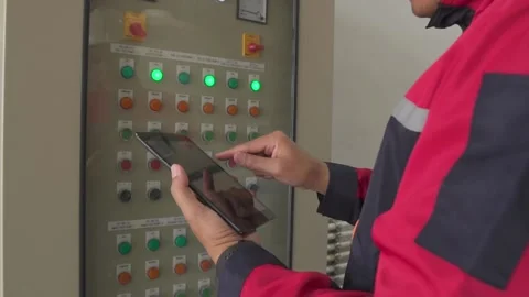 A Electrical Engineer working front HVAC control panels. Video stock 238432940