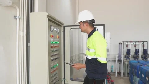 A Electrical Engineer working front HVAC control panels. Video stock 238432958
