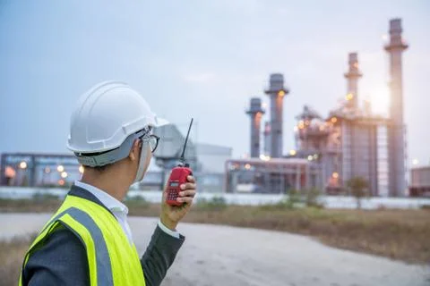 Electrical engineer working at power plant with walkie-talkie or radio commun Fotos de archivo