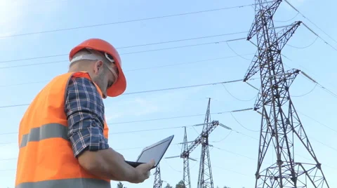 Electrical engineer working. Talking on the phone and working working on a la Video stock 64142623