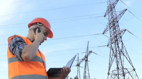 Electrical engineer working. Talking on the phone and working working on a la Stock Footage 64142932