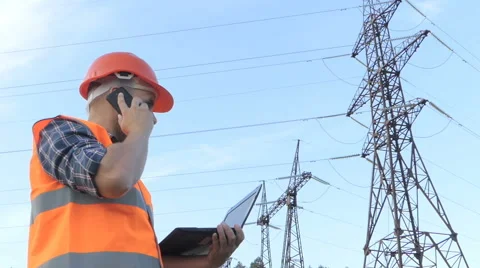 Electrical engineer working. Talking on the phone and working working on a la Stock Footage 66902012