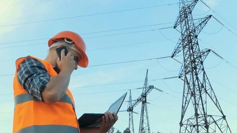 Electrical engineer working. Talking on the phone and working working on a la Stock Footage 78627078