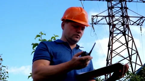 Electrical engineer working. Talking on the phone and working on the tablet. Stock Footage 91996495