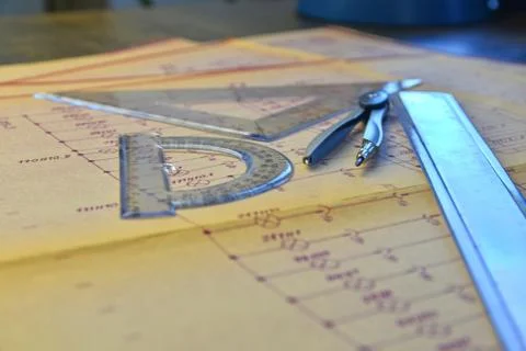 Electrical engineer workplace - electrotechnical project, rulers, and divider Stock-Fotos