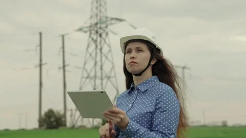 Electrical engineer works in hard hat with digital tablet, electrical business Stock Footage 246185902