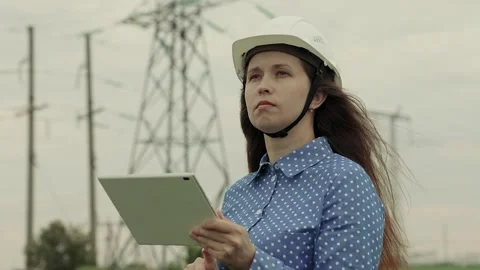Electrical engineer works in hard hat with digital tablet, electrical business Stock Footage 247499865