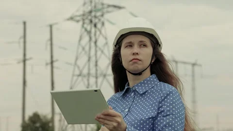 Electrical engineer works in hard hat with digital tablet, electrical business Stock Footage 247860808