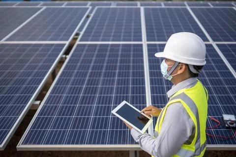 Electrical Engineering Examines Solar Panels in Renewable Energy Generation Stock Photos