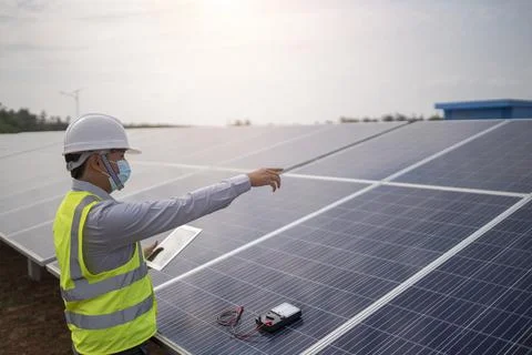 Electrical engineering works on controlling solar panels to produce renewable Stock Photos