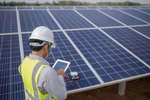 Electrical engineering works with solar panels to produce renewable energy. Stock Photos