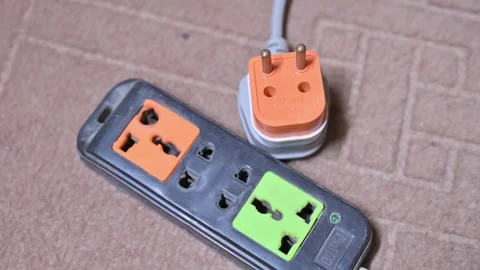 Electrical Extension Board and Two Pin Power Plug Isolated on Indoor Surface Stock Footage 337136572
