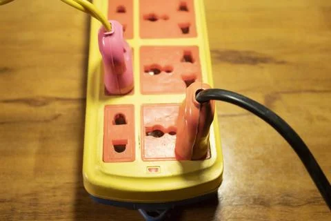 Electrical extension cord with plug in socket Stock Photos