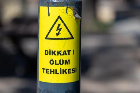 Electrical Hazard Warning Sign in Turkish on Metal Post Stock Photos