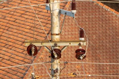 Electrical installation network with concrete poles on the streets side by si Stock Photos