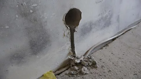 Electrical installation work in a concrete renovation wall Stock Photos