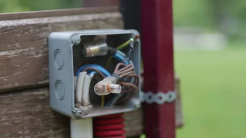 Electrical junction box with visible wires and components mounted on wooden Stock Footage 340554024