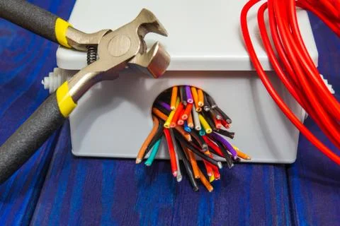 Electrical junction boxes with cable wires and tool usually used in the electric Stock Photos