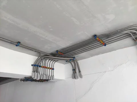 Electrical line in tubes attached on the ceiling. neatly lined infrastructure Stock Photos