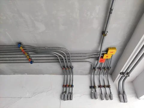 Electrical line in tubes attached on the ceiling. neatly lined infrastructure Stock Photos
