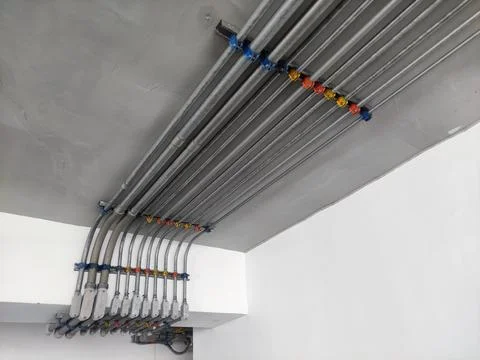 Electrical line in tubes attached on the ceiling. neatly lined infrastructure Stock Photos