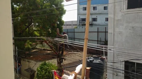 Electrical Lineman Sitting on Concrete Utility Pole Inspecting Overhead Power Stock Footage 346485648