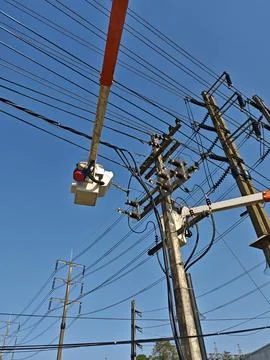 Electrical lineman team working on concrete riser pole maintenance. Stock Photos