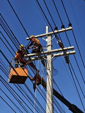 Electrical lineman technician installing twisted aerial bundle cable. Stock Photos