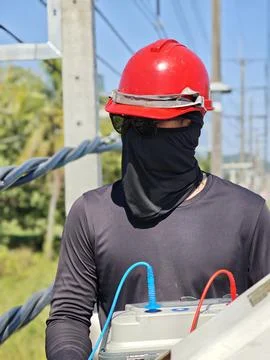 Electrical lineman testing insulation resistance of twisted aerial bundle c.. Stock Photos