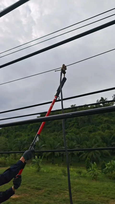 Electrical lineman worker rotating hot stick to install temporary ground cl.. Stock-Footage 338017362