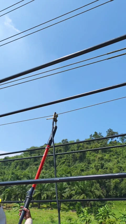 Electrical lineman worker rotating hot stick to install temporary ground cl.. Stock Footage 338017384