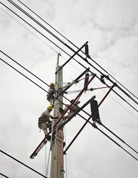 Electrical lineman worker team replacing high voltage suspension insulators.. Stock Photos