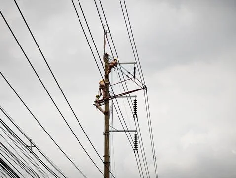 Electrical lineman worker team replacing high voltage suspension insulators.. Stock Photos