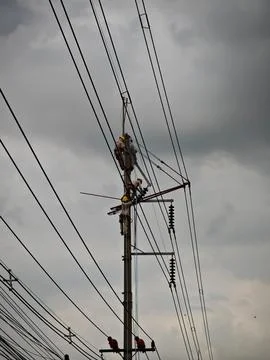Electrical lineman worker team replacing high voltage suspension insulators.. Stock Photos