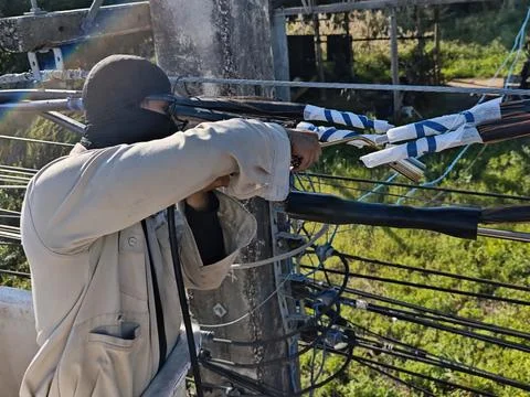 Electrical lineman worker using gas torch to heat shrink insulation. Stock Photos